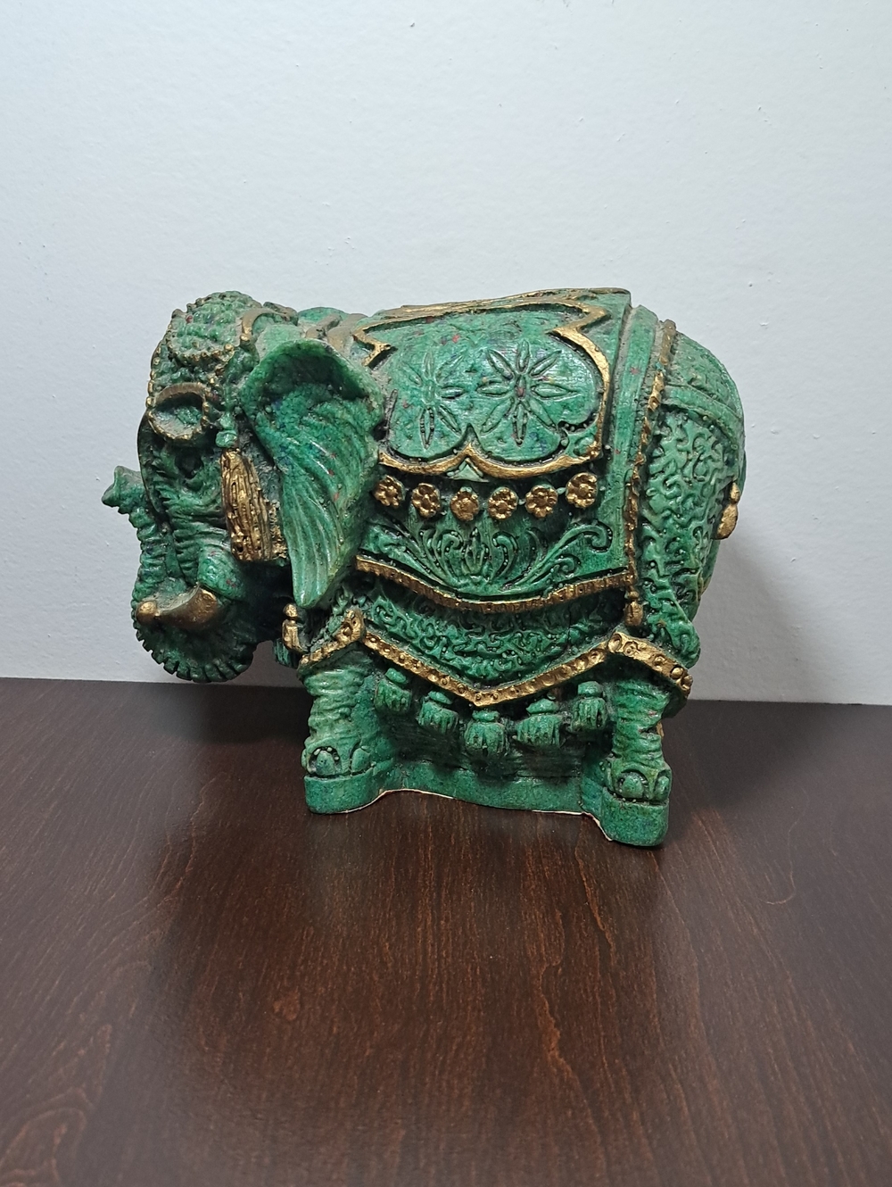 Decorative elephant figurine finished in antique green with gold-colored. Heavy